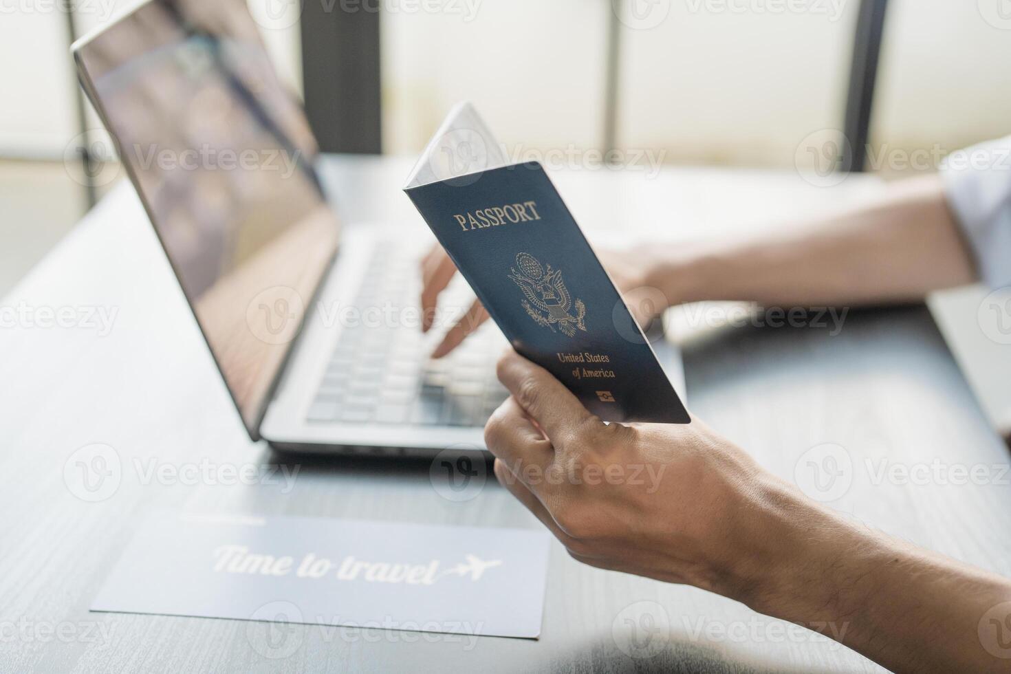 Hand Man Online booking and buying plane tickets using laptop phone and credit card Planning trip travel photo