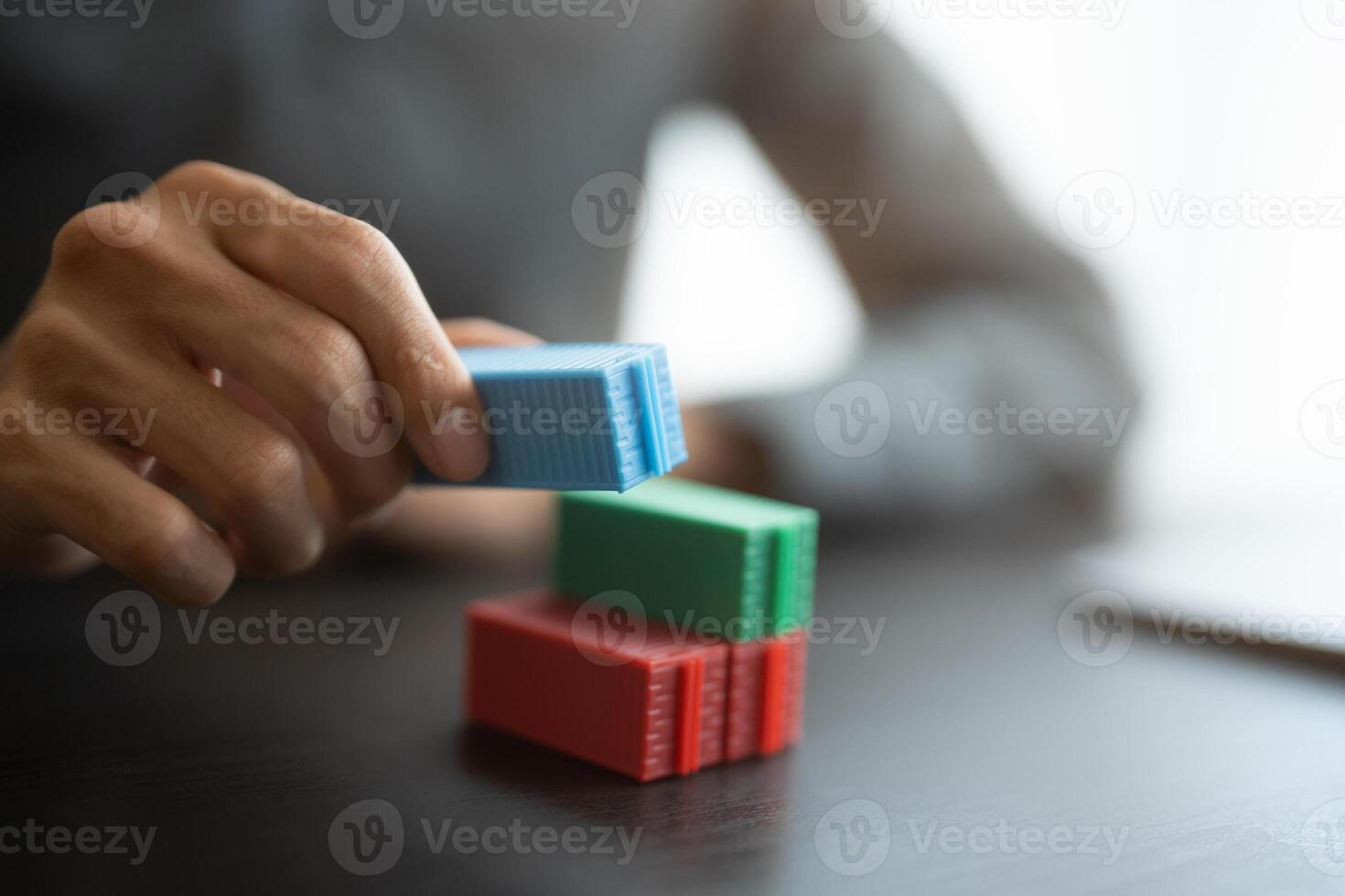 a person is stacking blocks on a table photo