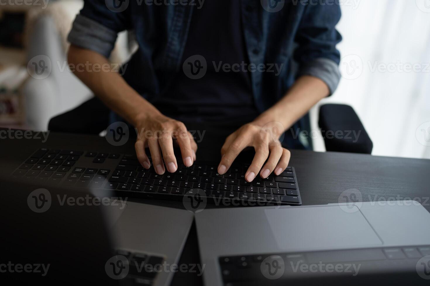 Asian man software engineer Working on Computer at office desk for writing program IT Software Engineer finding errors tech support devops creating digital photo