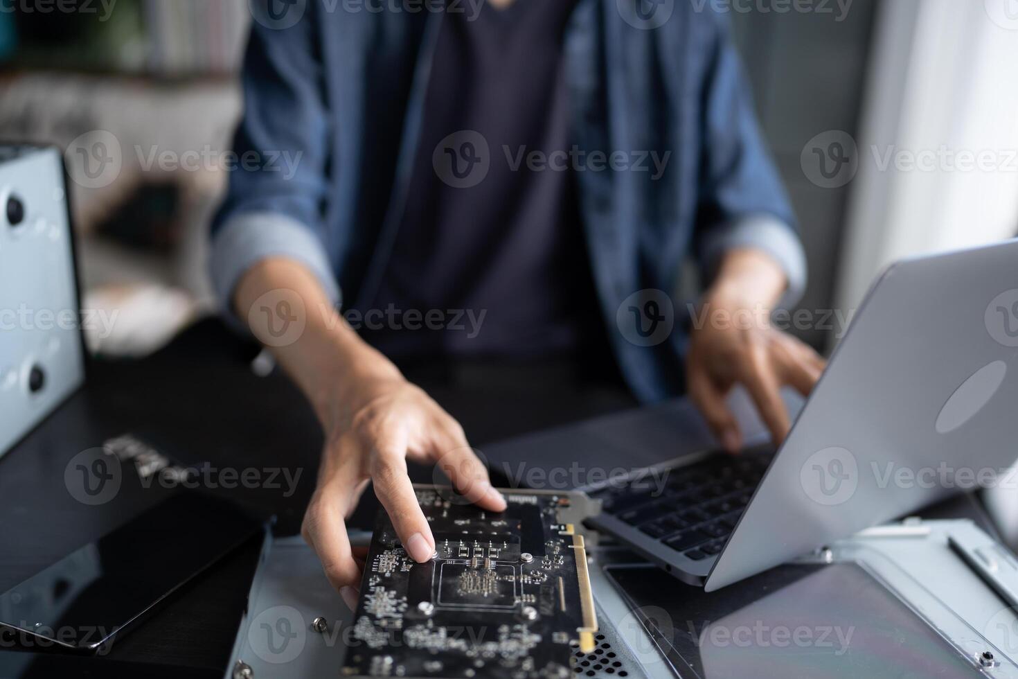 a person is working on a laptop computer with a motherboard photo