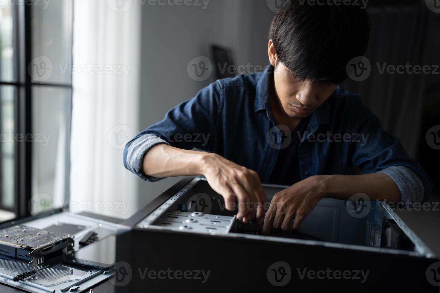 a man is working on a computer with a case photo