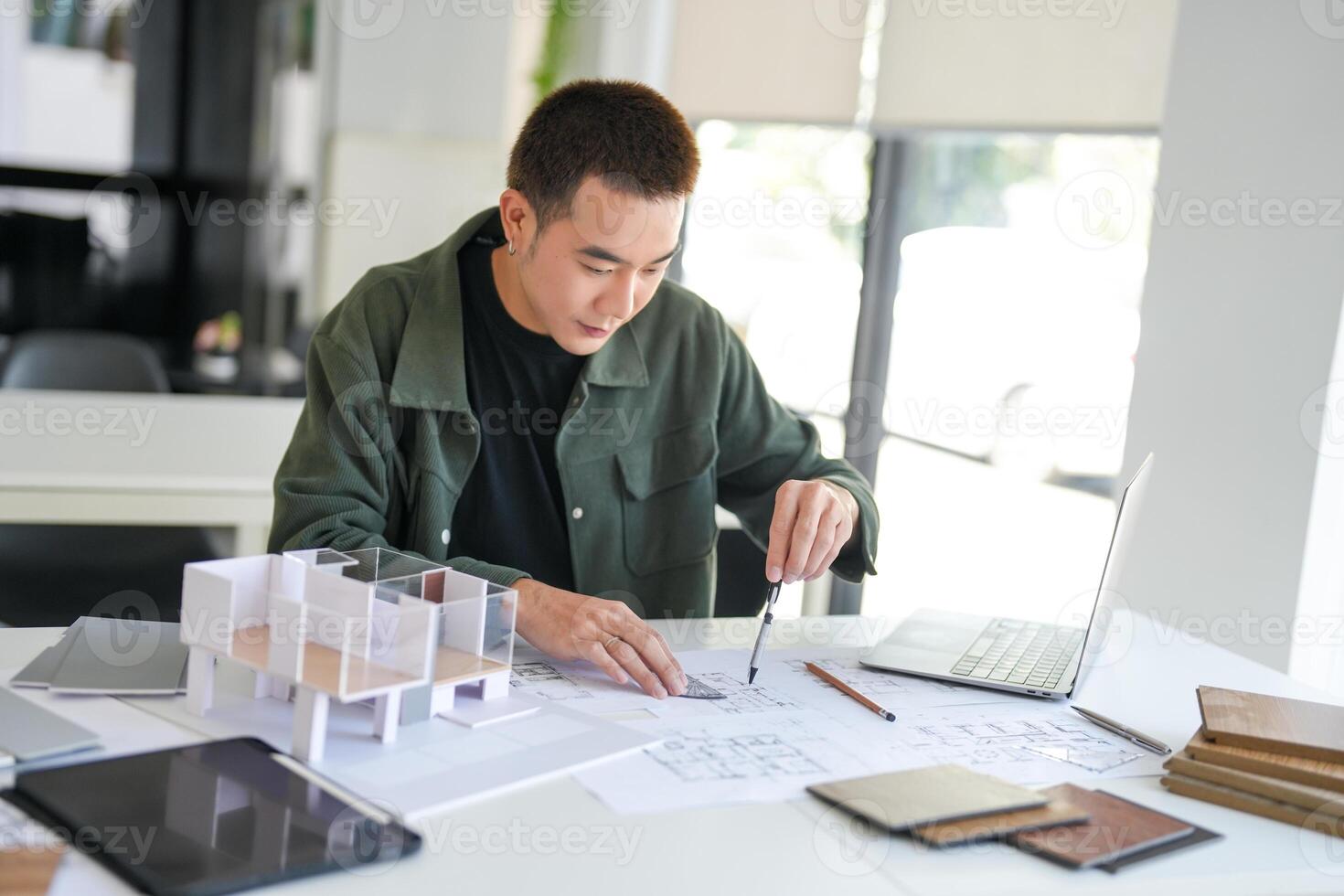 a man is working on a project at a desk at office photo
