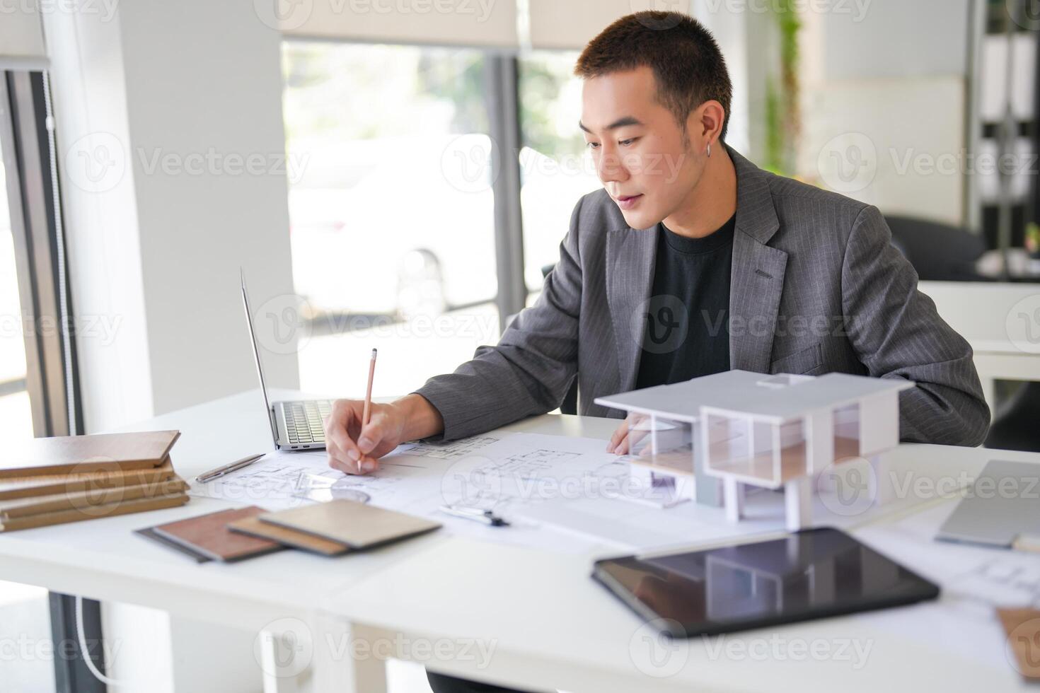 a man in a suit is working on a project photo