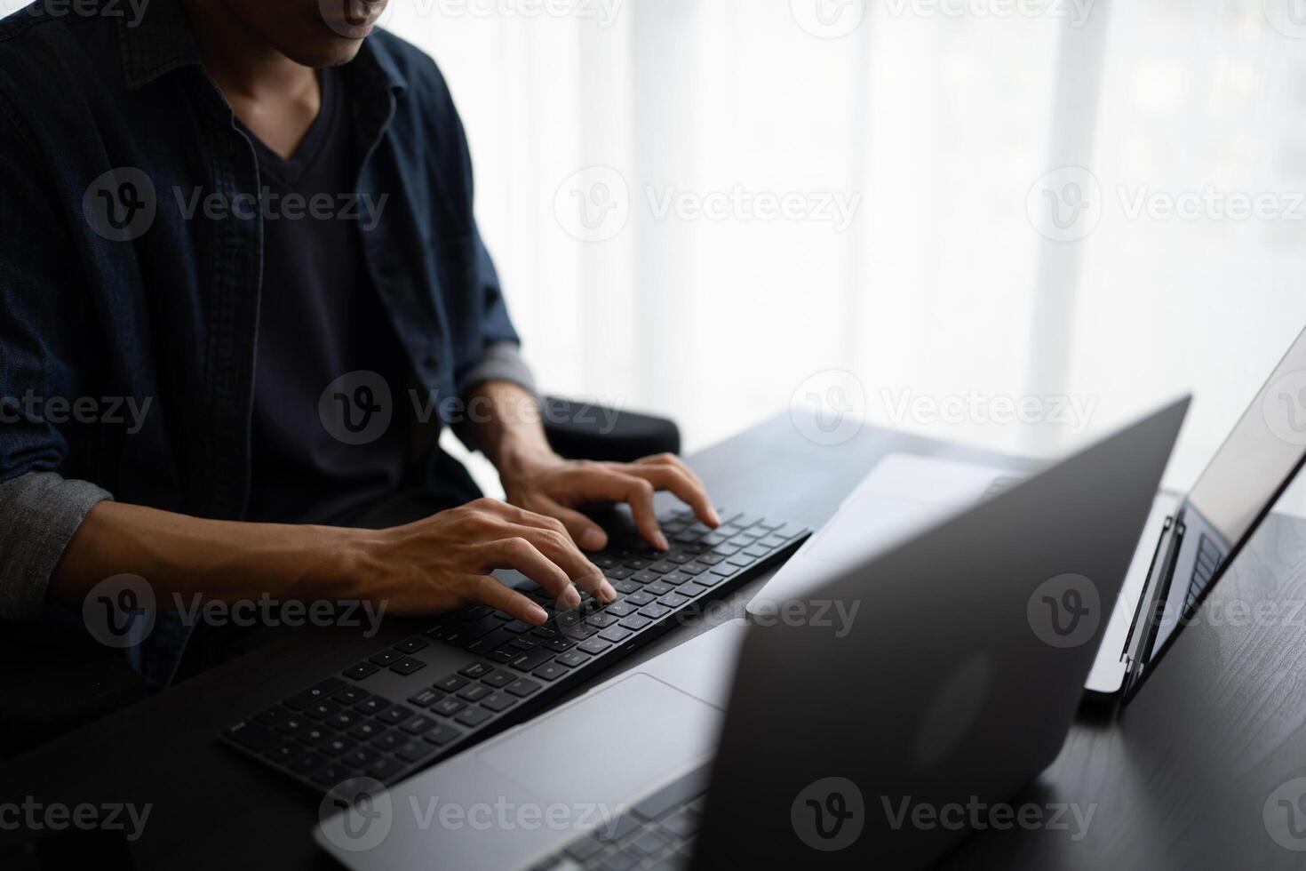 Asian man software engineer Working on Computer for writing program code Software Engineer finding errors tech support devops creating digital photo