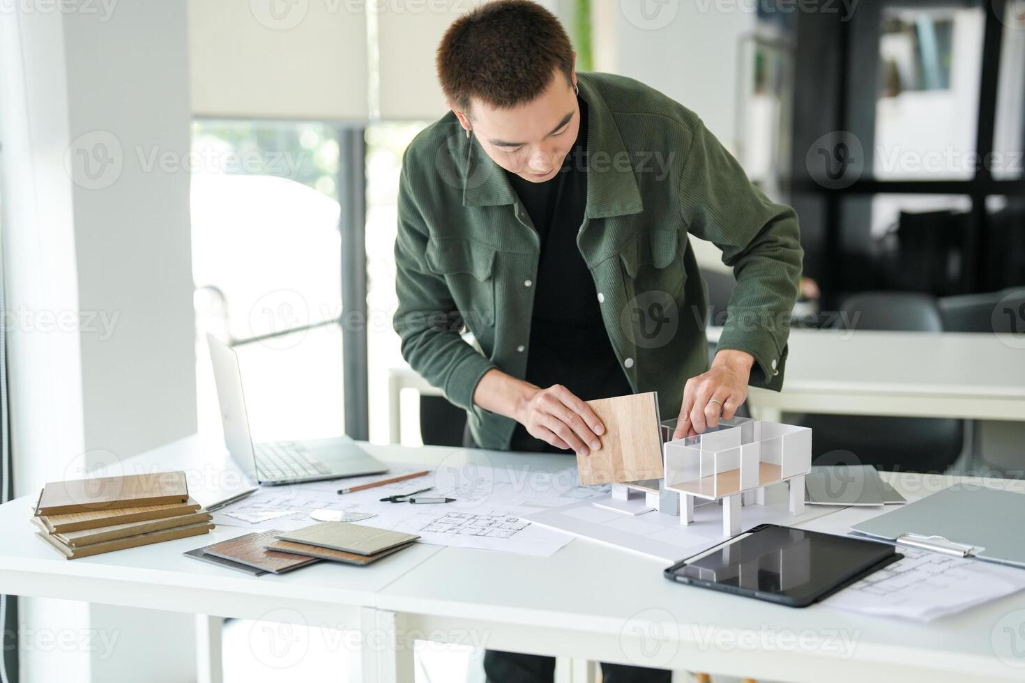 a man is working on a project with a laptop photo