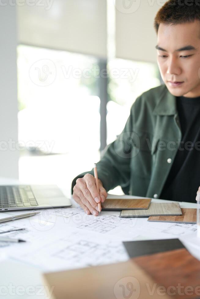 a businessman is working on a project at a desk photo
