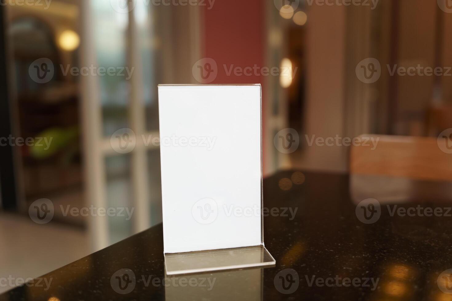 Mock up Menu frame standing on wood table in restaurant photo