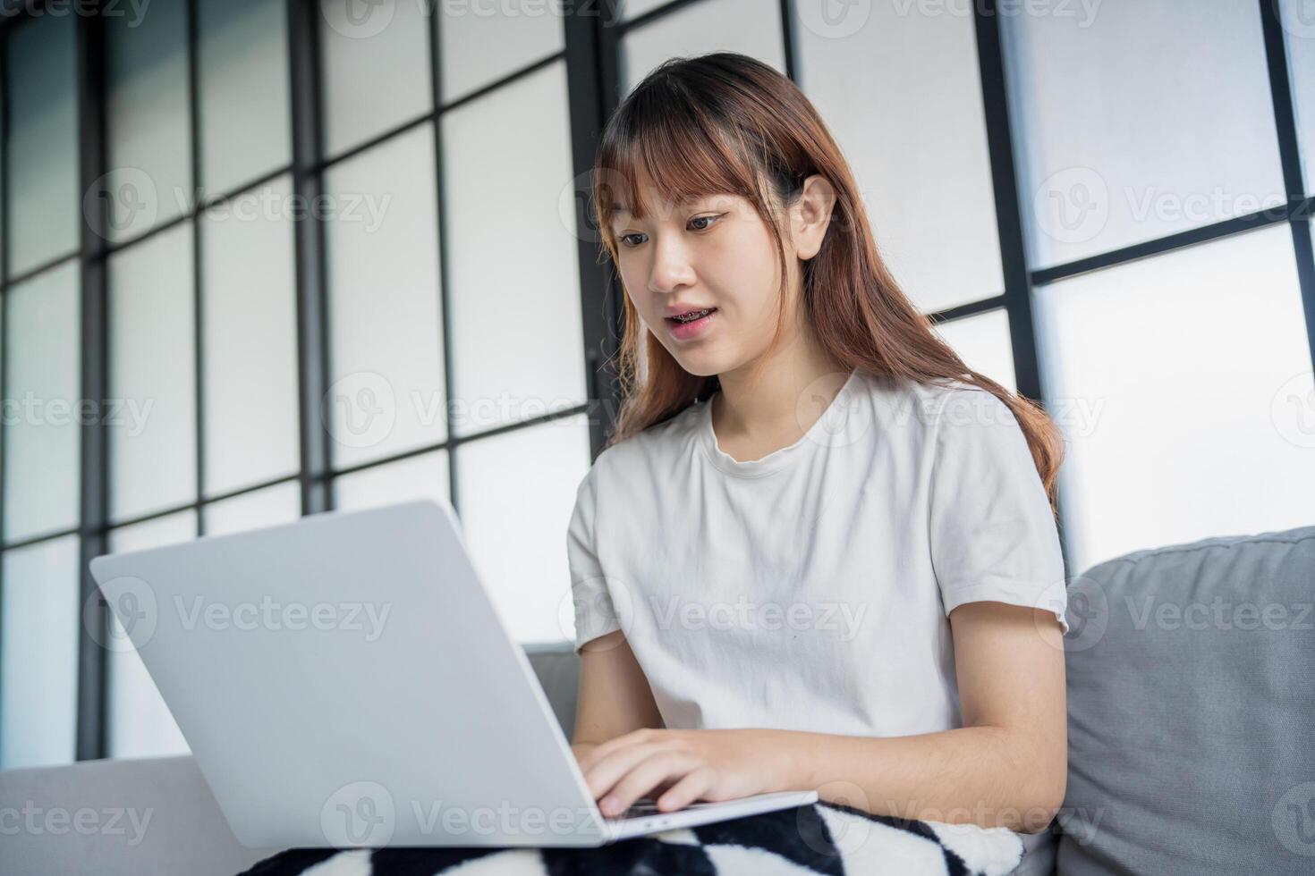 Asian woman watching entertainment vdo streaming by laptop at home photo