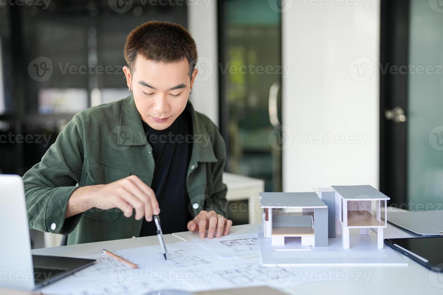 a man is working on a model of a house photo