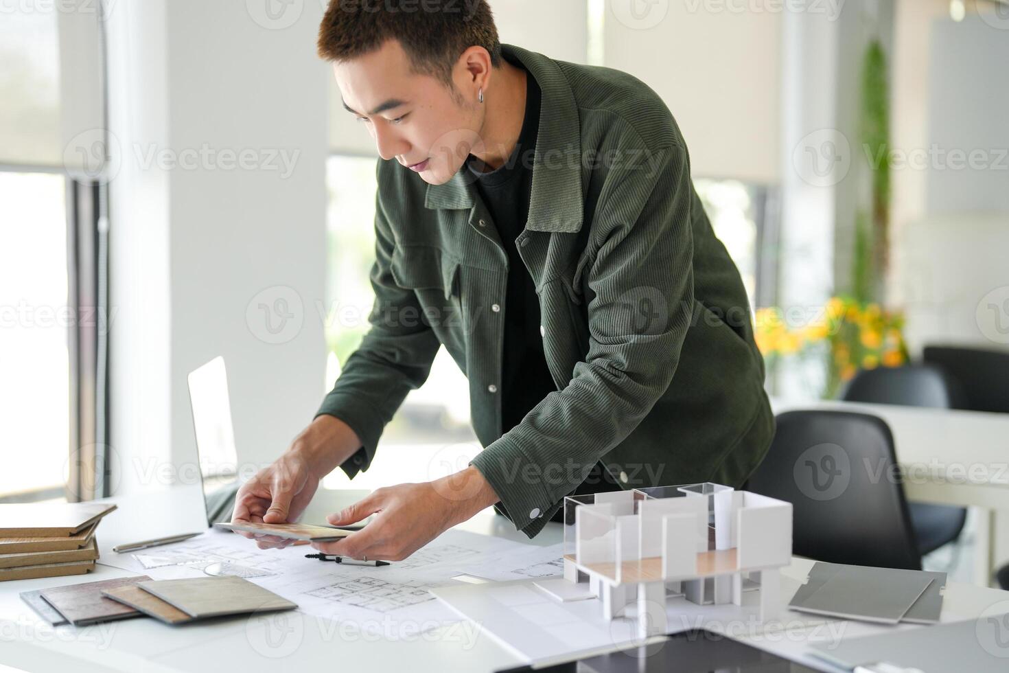 a man is working on a project at a desk photo