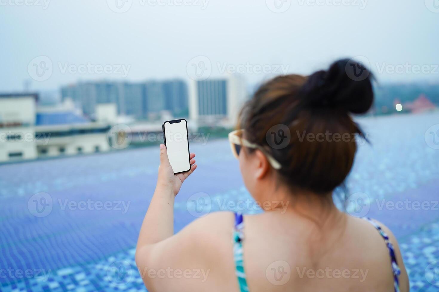 Obese Woman Vacation Traveling hand using phone telephone blank copy space screen smart phone relaxing in swimming pool photo