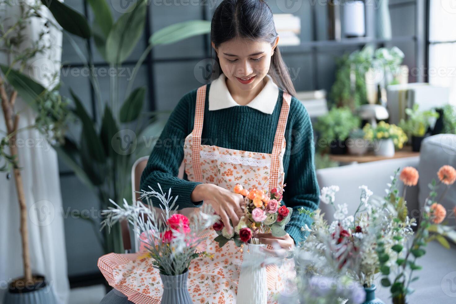Happy asian female florist Startup successful SME in flowers shop photo