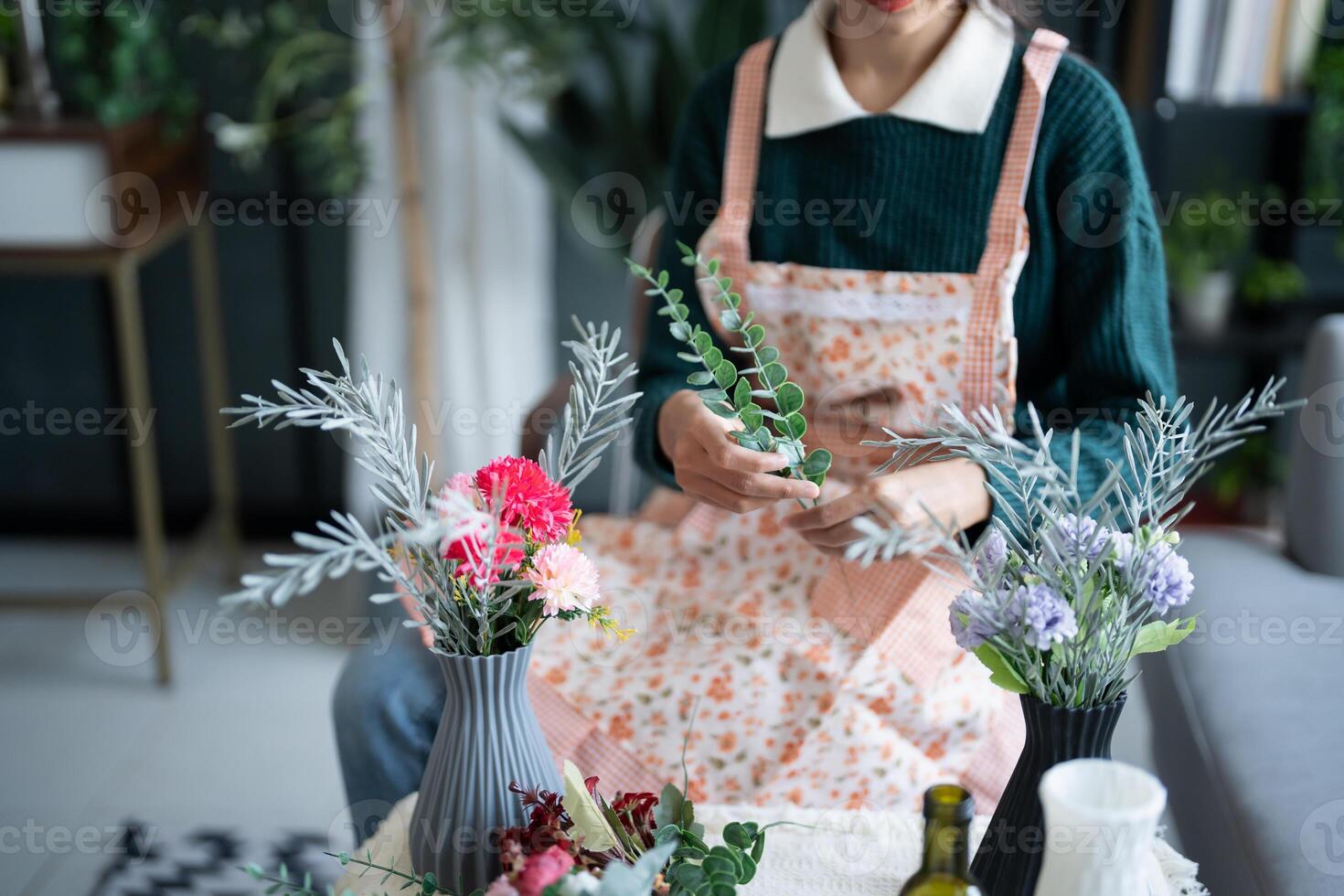 Woman arranging flowers for home greenery photo