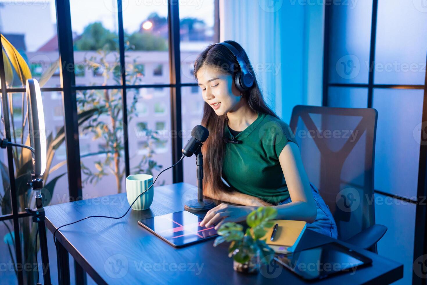 Content creator woman influencer creating content in home studio entertainment and communication blogger vdo record with smartphone for online vlog photo