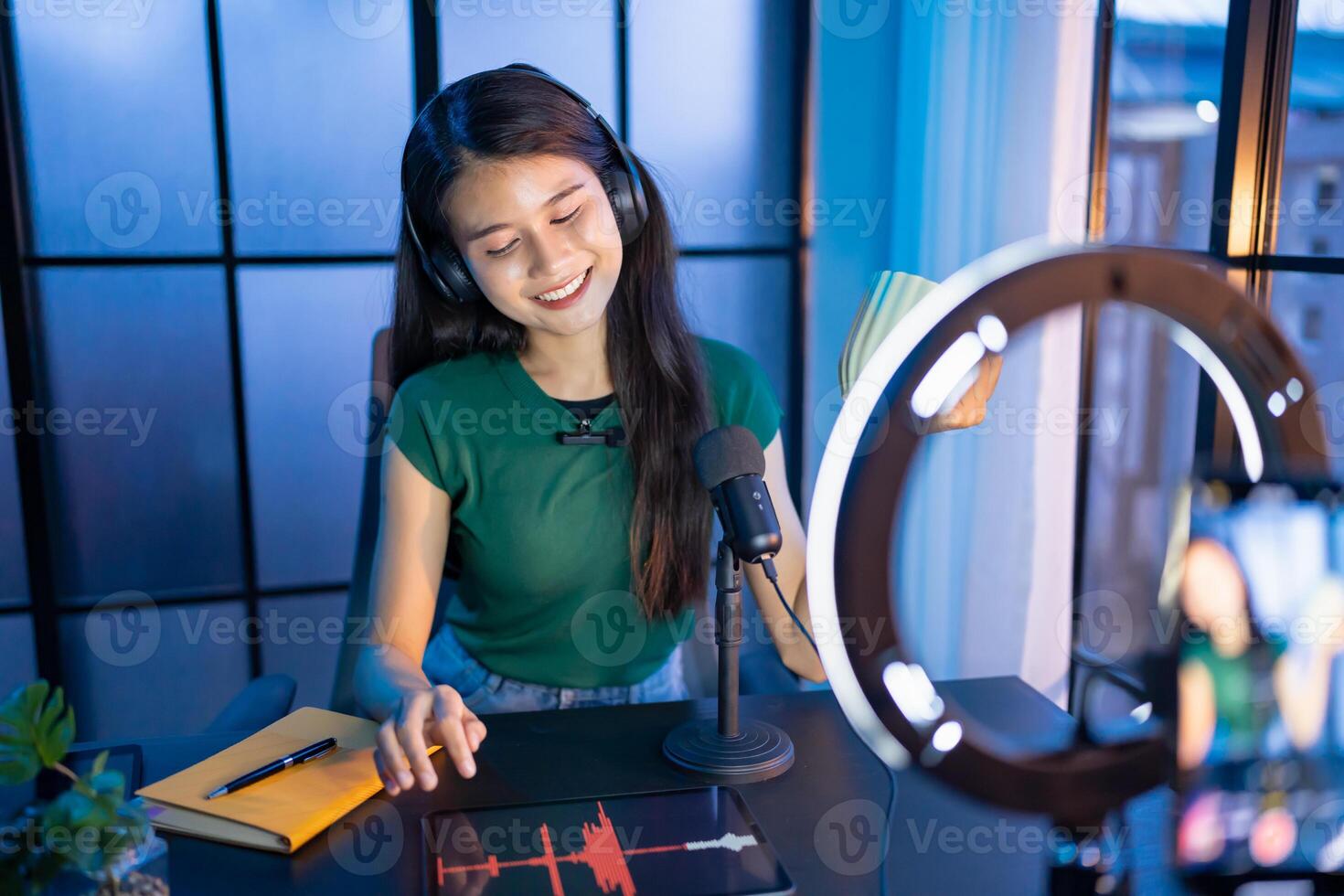 Young asian woman influencer creating content in home studio entertainment and communication blogger vdo record with smartphone for online vlog photo