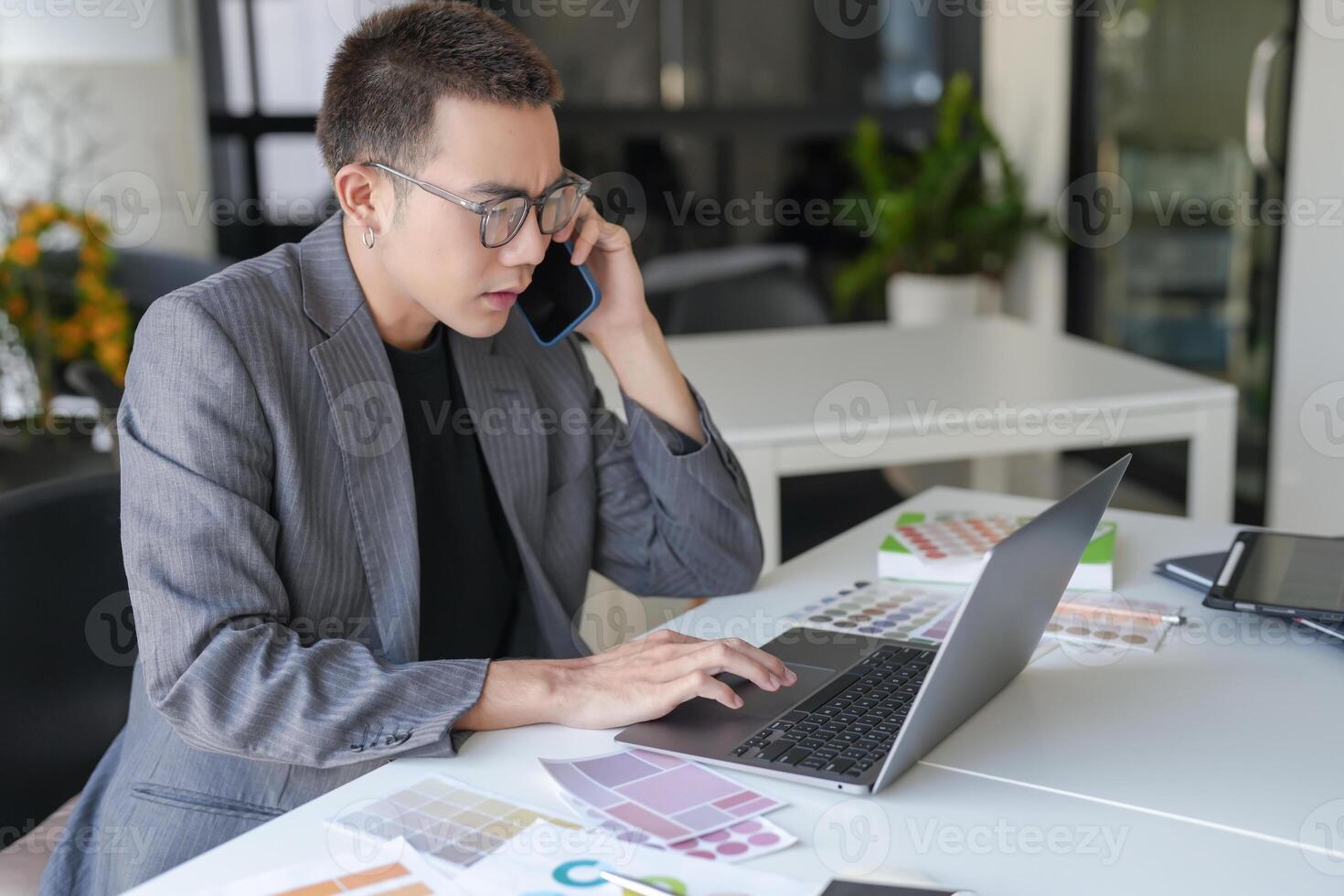 Asian Businessman Designer sketch graphic drawing on graphic laptop and Color swatch samples Concept of idea creativity photo