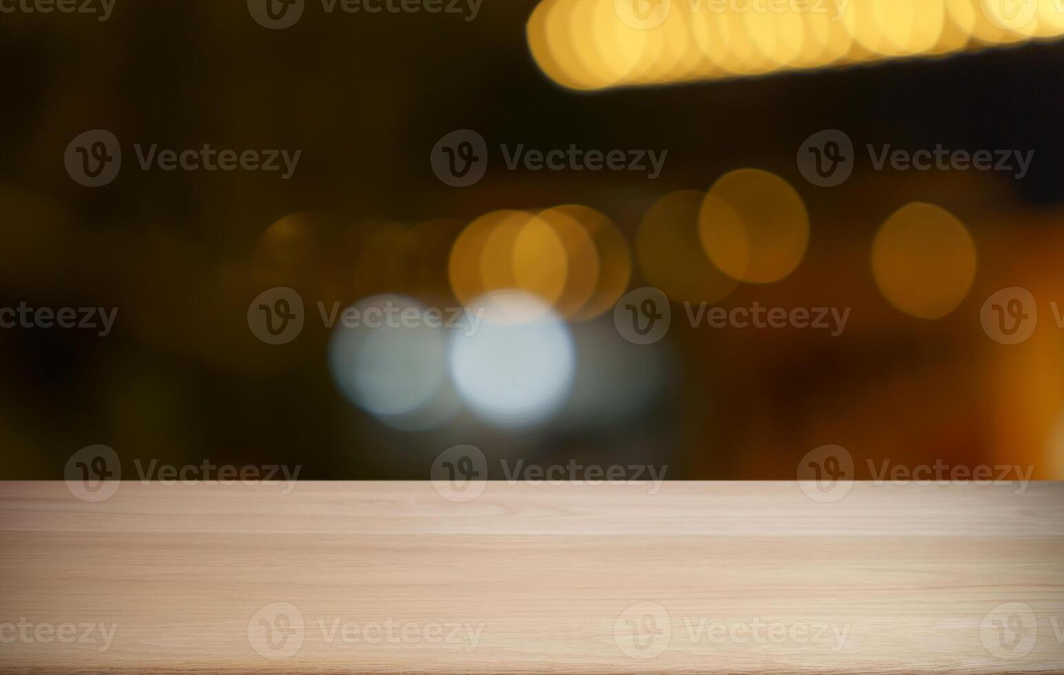 empty wooden table top on blurred background with bokeh effect photo