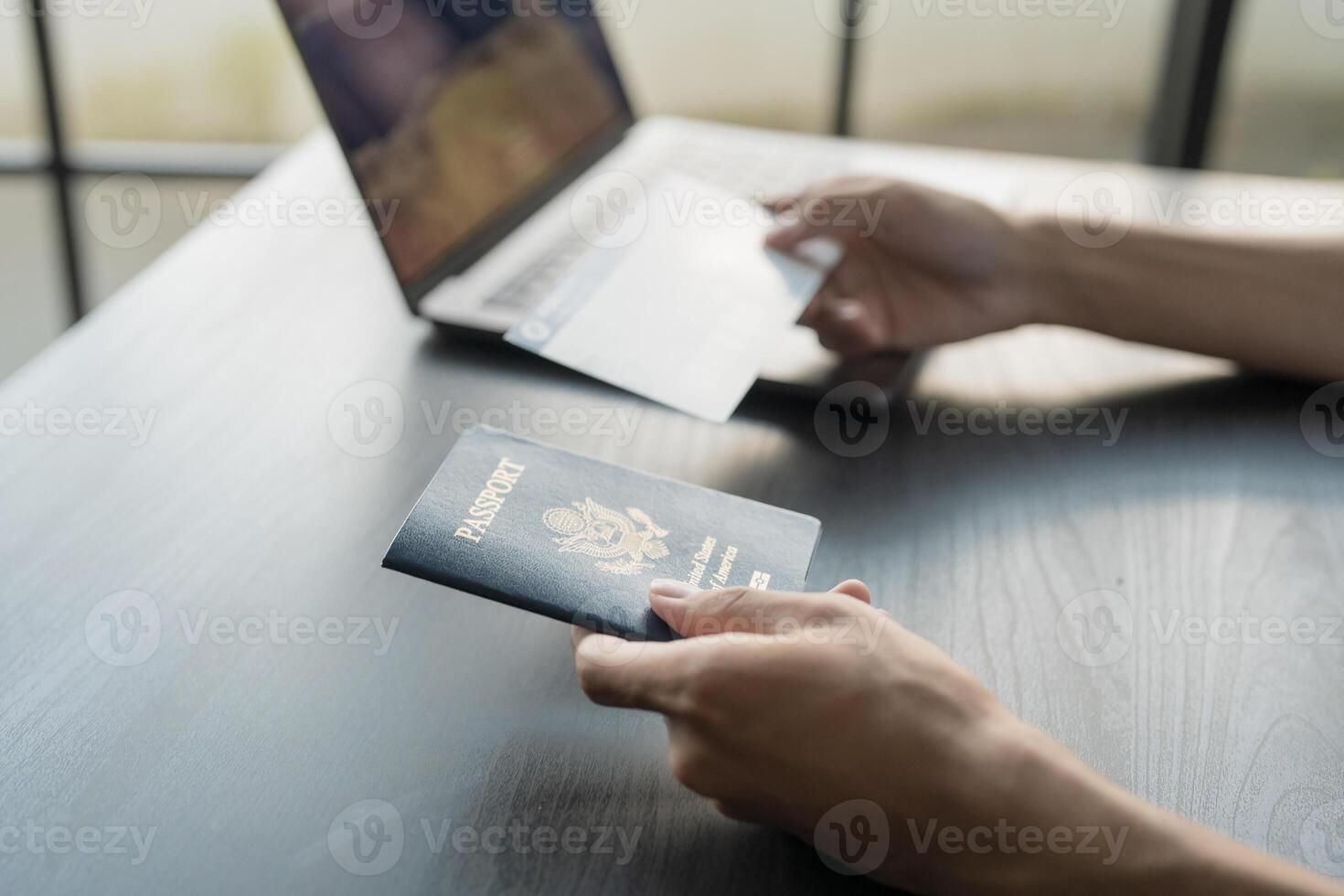 man holding passport and credit card on table photo