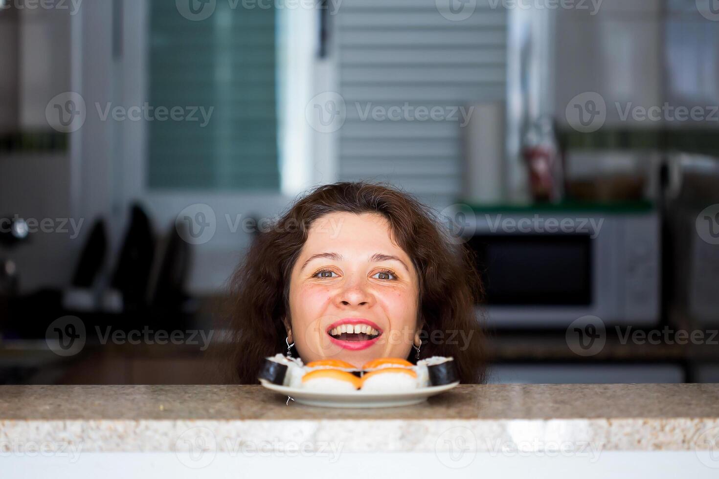 Funny picture of woman with Sushi at the kitchen. Fun, joke and humor concept. photo