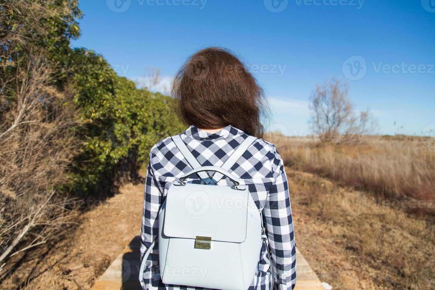 Young woman wearing a blue backpack - travel and vacation concept photo