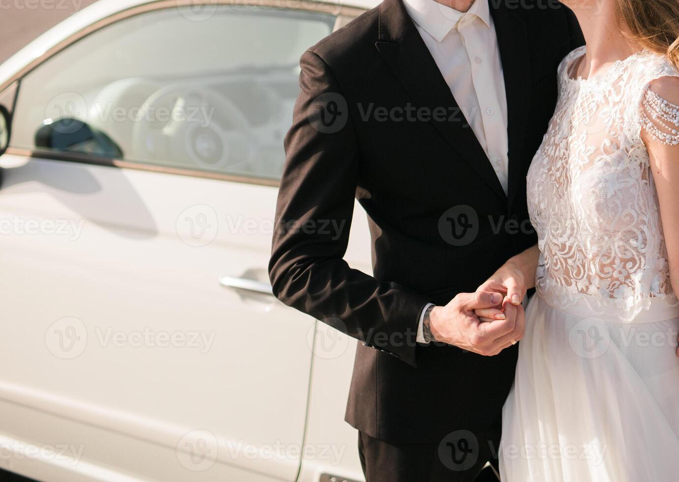 The bride and groom hold hands on their wedding day ir in love on a sunny day. Wedding concept. Copy space photo