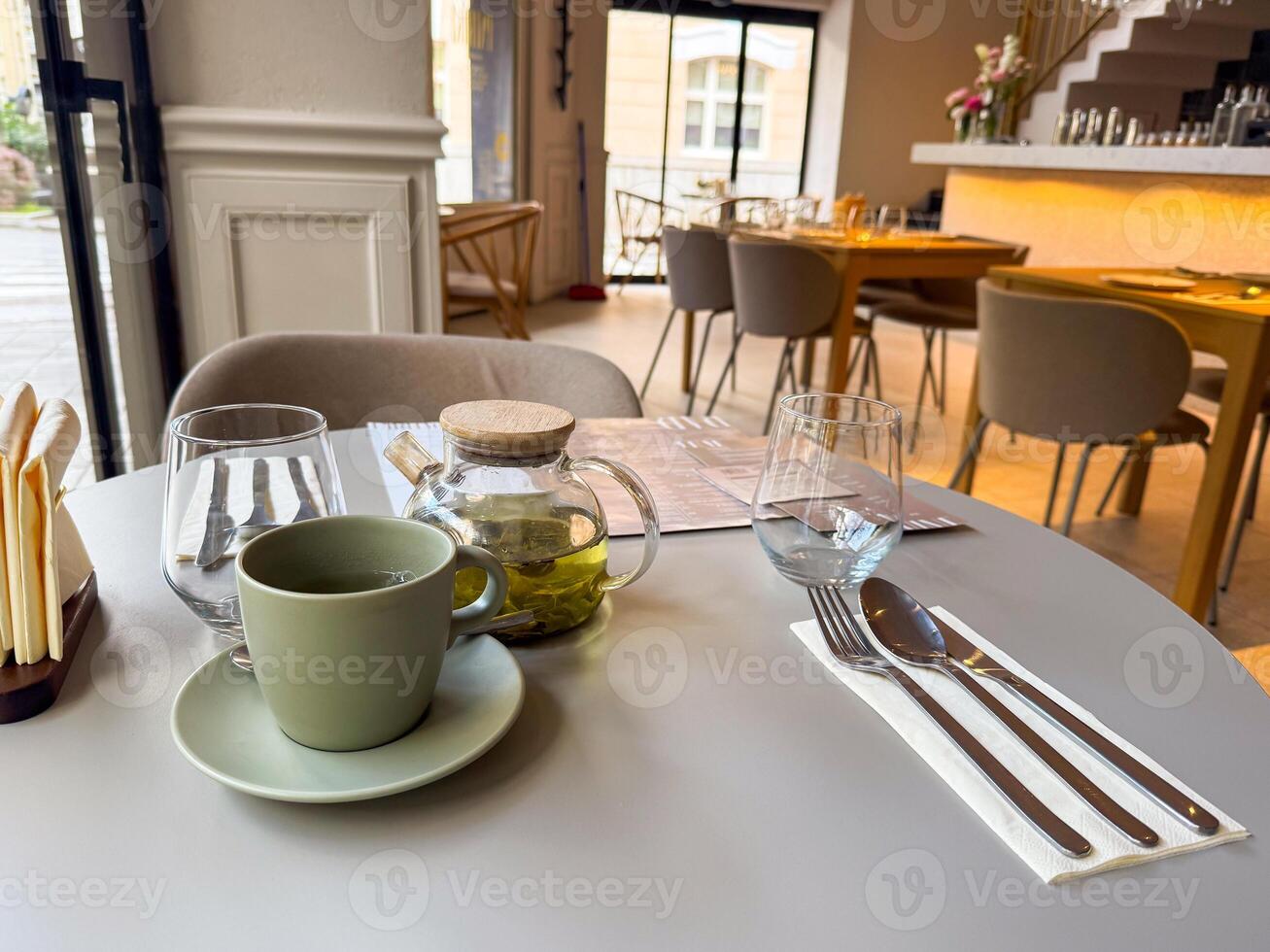 Hot green tea served at a cozy urban cafe table photo