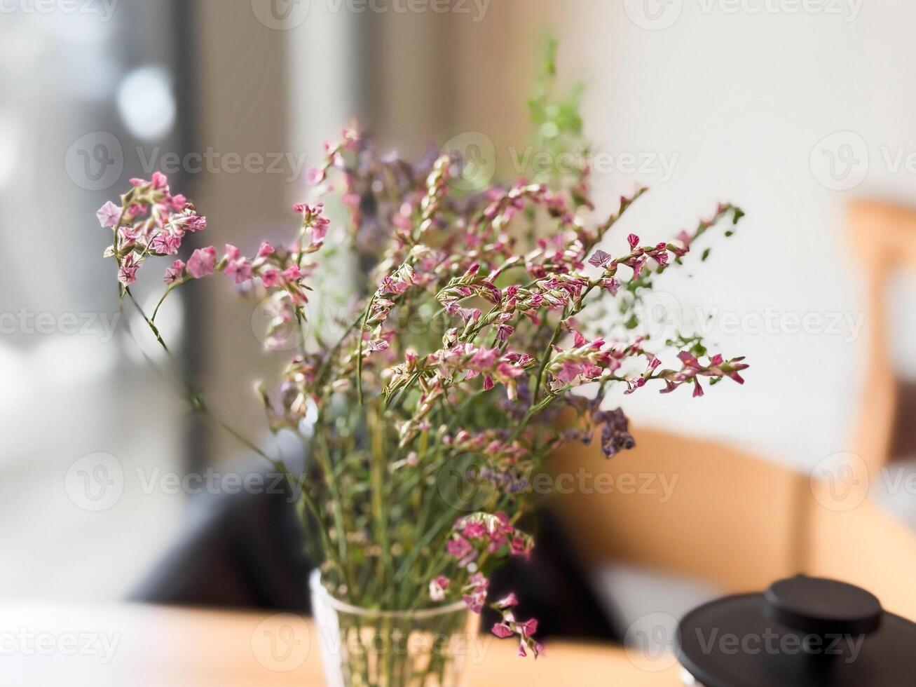 Flowers bring calm to the cafe table. Natural beauty and quiet detail in lifestyle settings photo