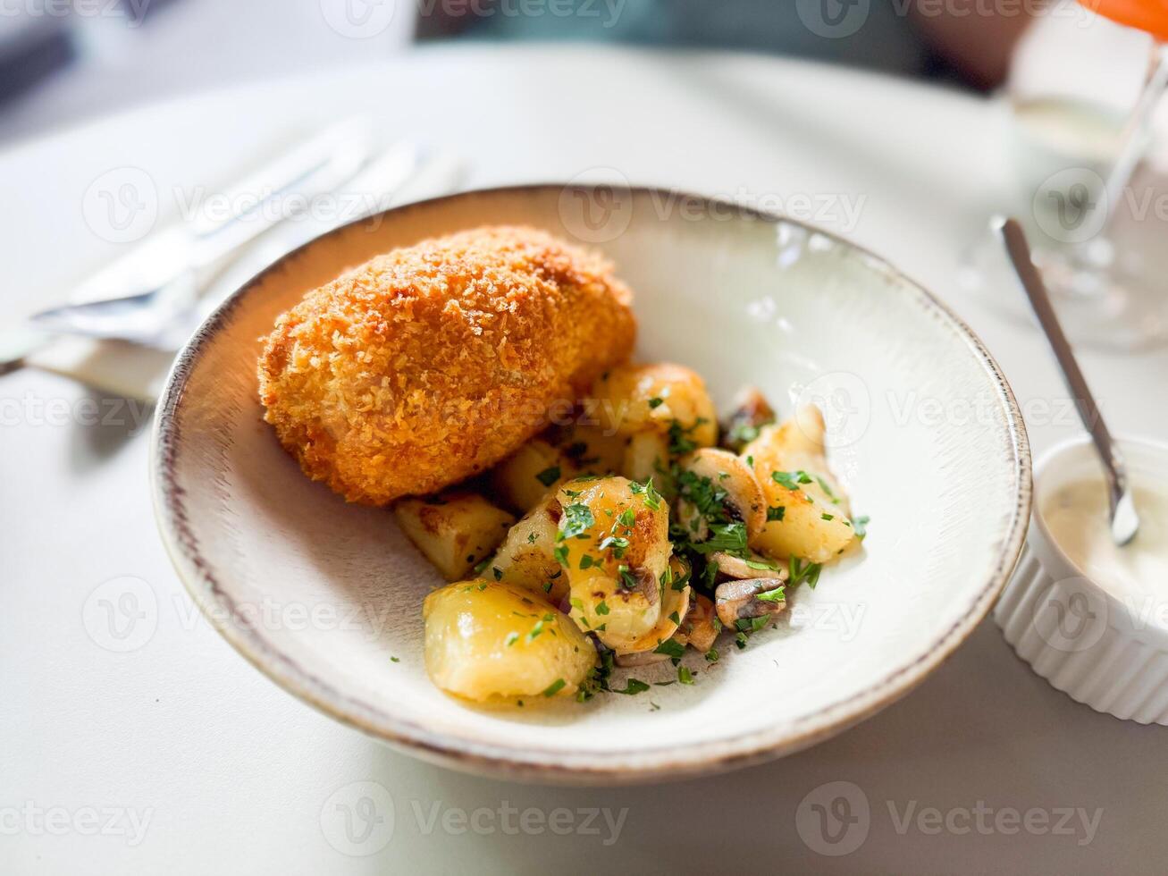 Kiev style chicken cutlet served with mashed potatoes photo