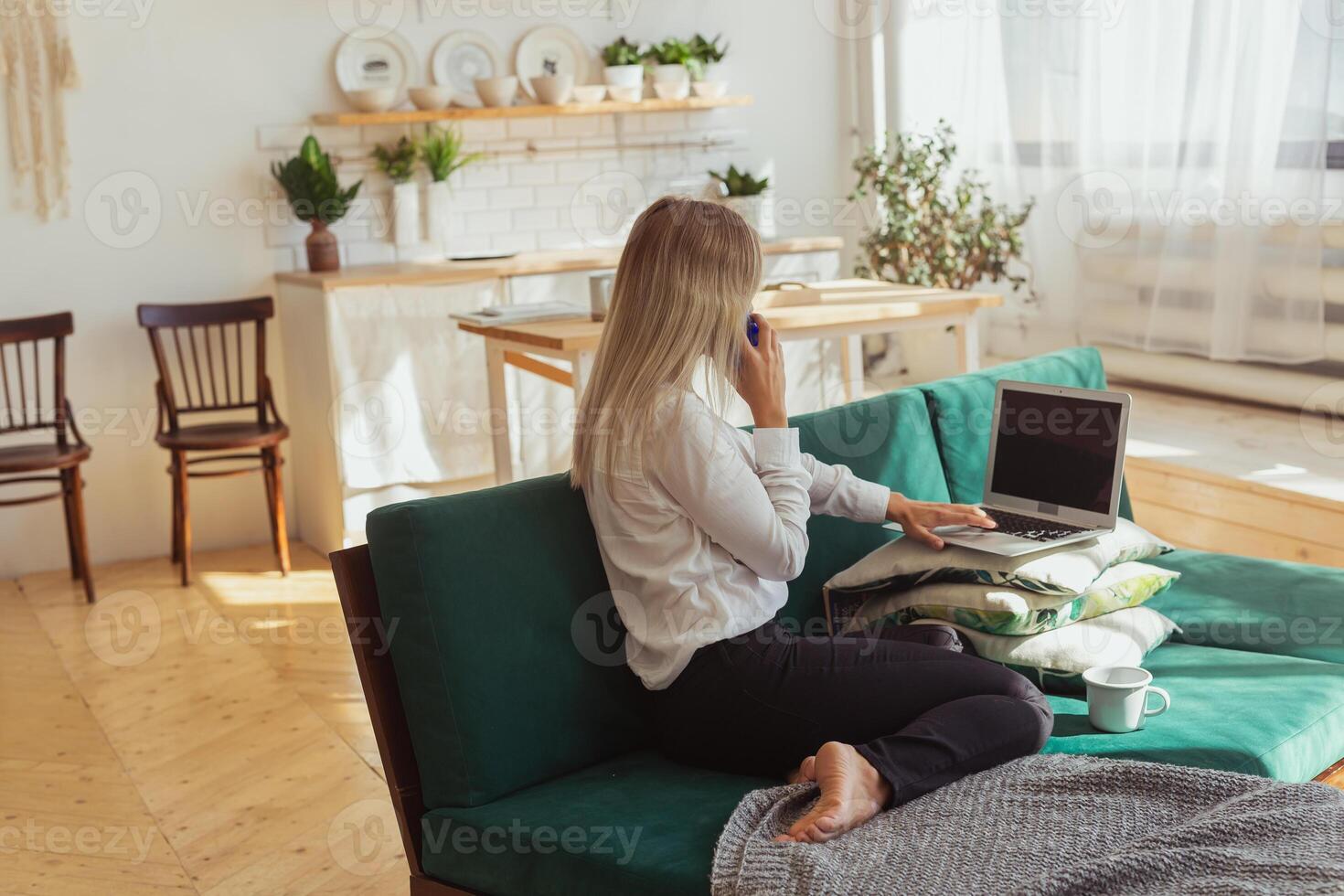 Woman talking on smartphone while working remotely. freelance concept photo