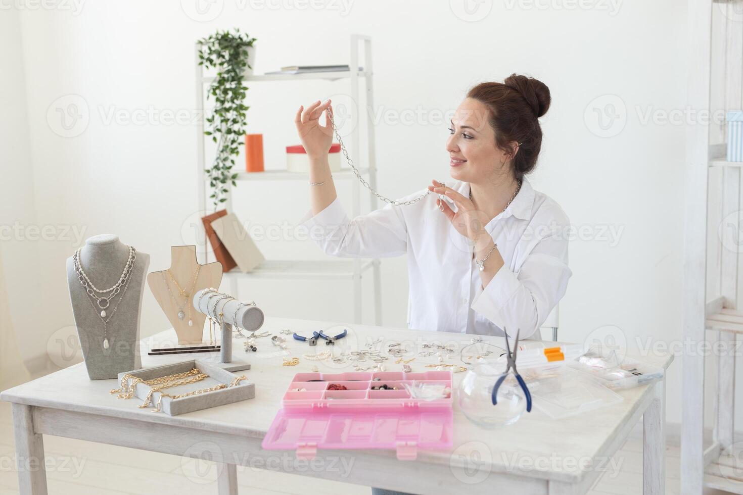 Designer making handmade jewelry in studio workshop. Fashion, creativity and handmade concept. photo