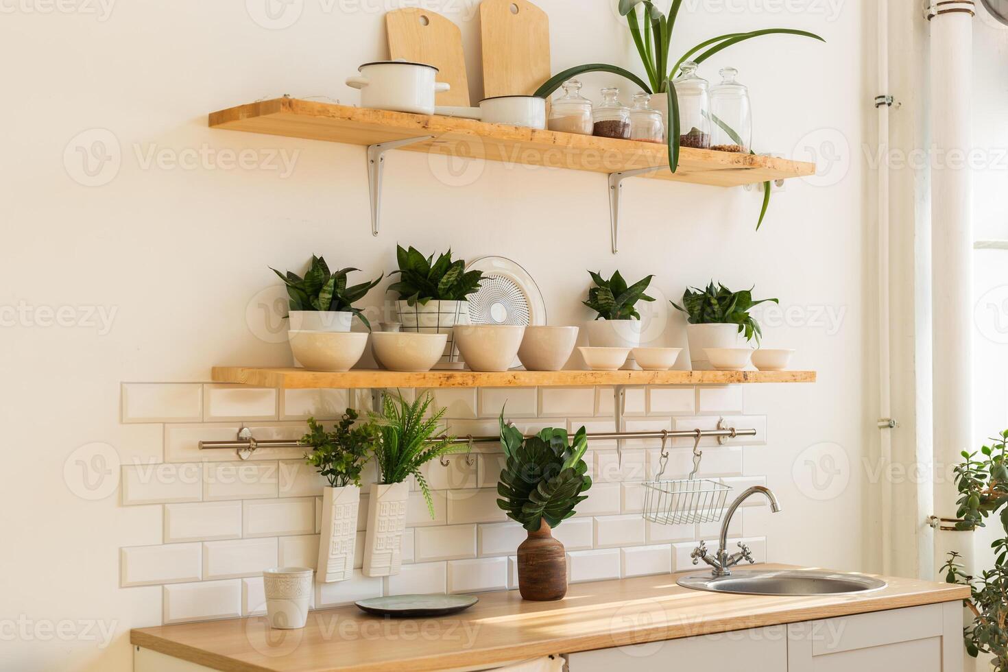 Stylish scandinavian kitchen with accessories and plants. photo