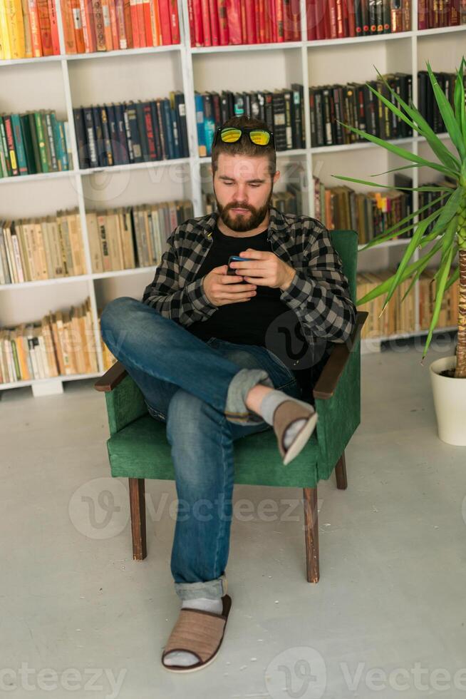 Attractive smiling hipster man relaxing at home. Gen Z and millennial photo
