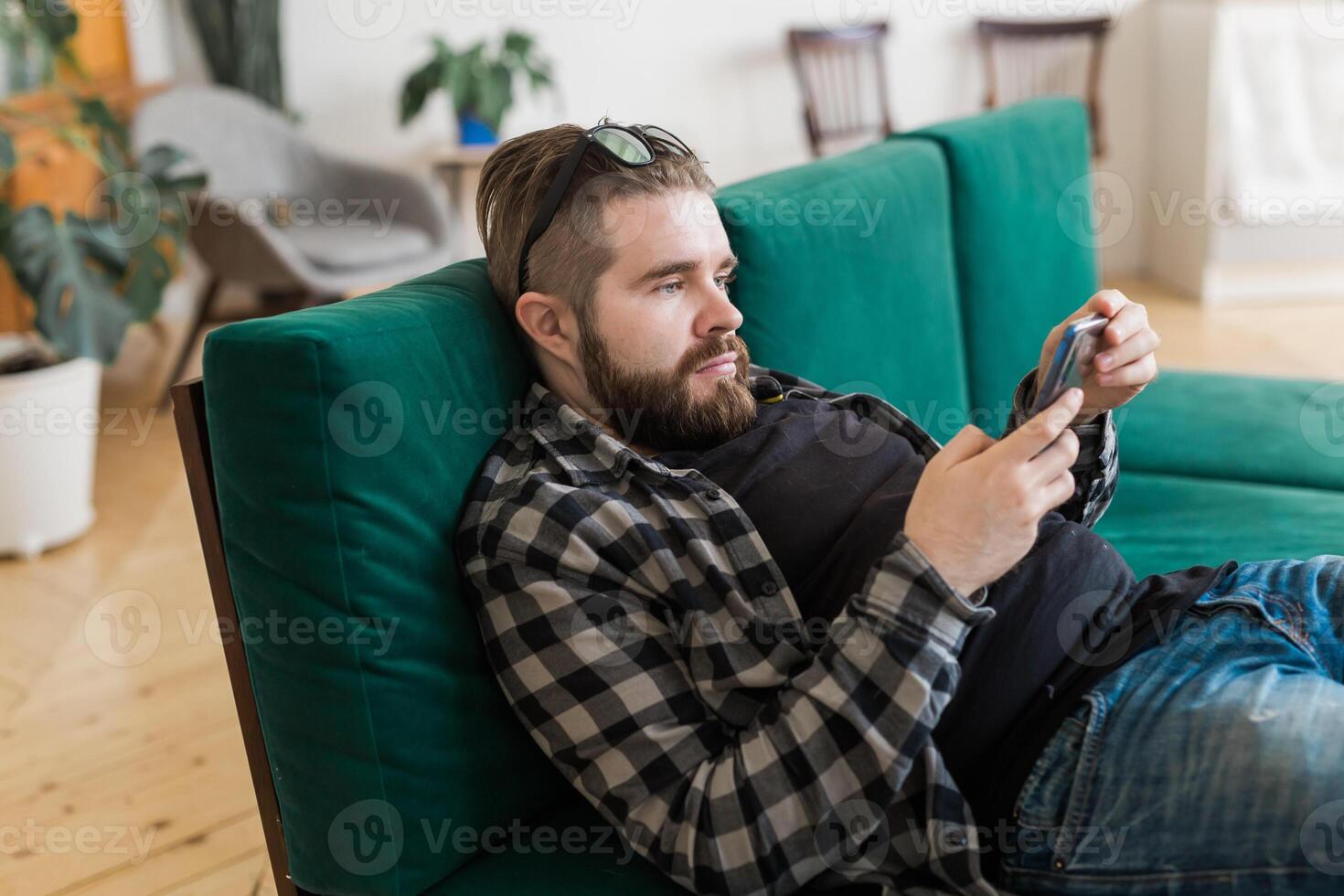 Young man surfing on social networking site using smartphone. Technologies photo