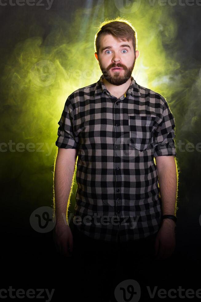 Emotional stunned handsome male has mustache and beard, being shocked with sudden raise of prices, expresses surprised photo