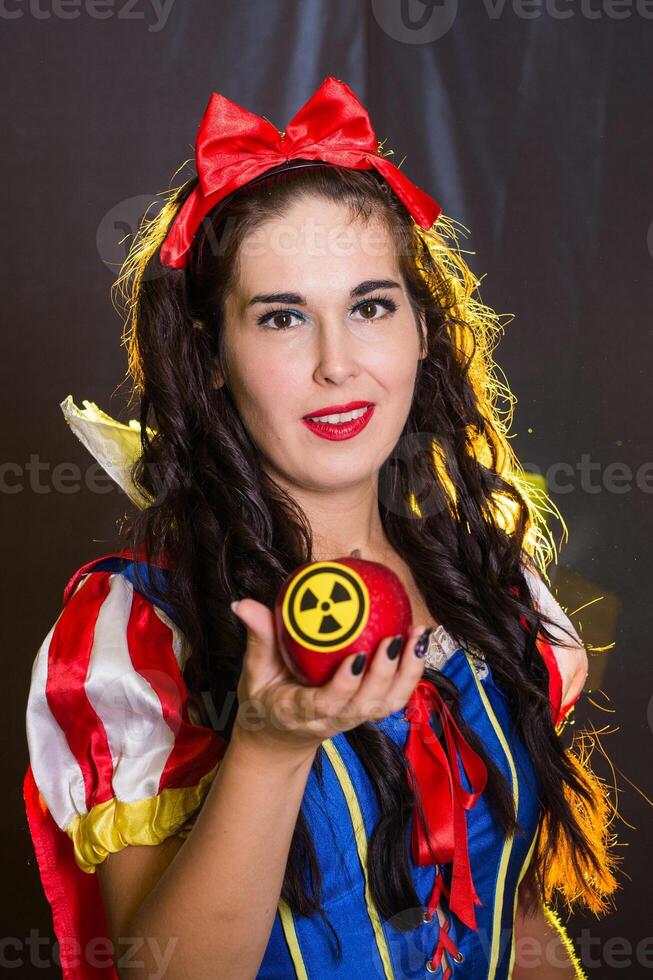 Happy Woman holding hazardous radioactive apple. Nuclear and radiation measurement concept. photo