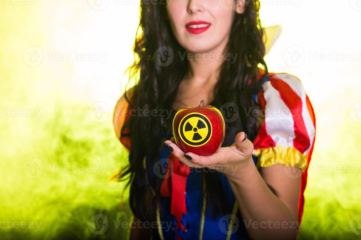 Danger, nuclear and radiation measurement - Girl holds apple with radiation hazard symbol, close-up. photo