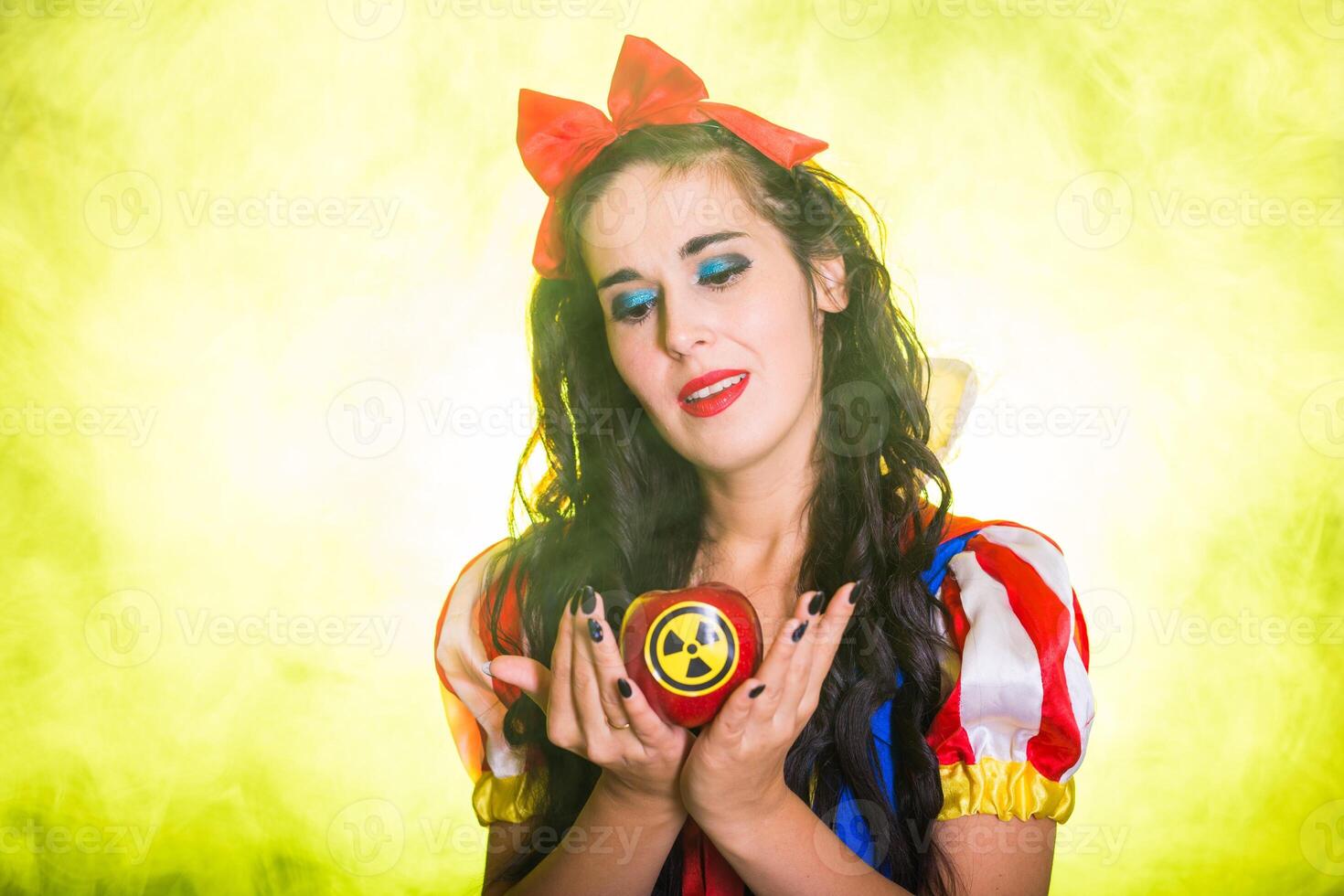 Danger, nuclear and radiation measurement - close-up Portrait of Girl holds apple with radiation hazard symbol. photo
