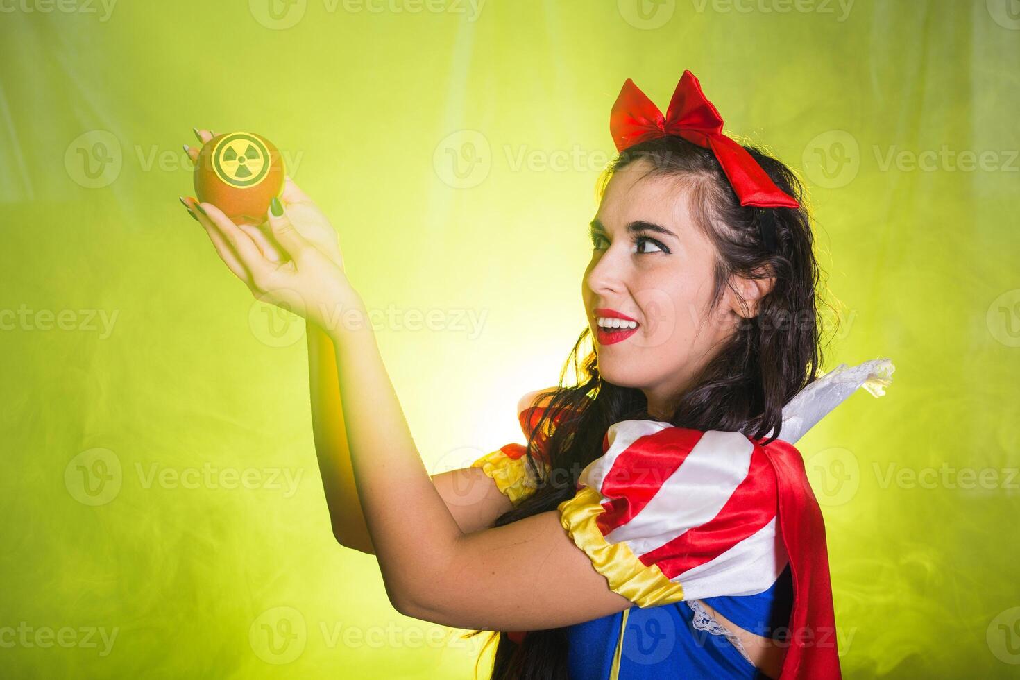 Female portrait holding hazardous radioactive apple. Nuclear and radiation measurement concept. photo