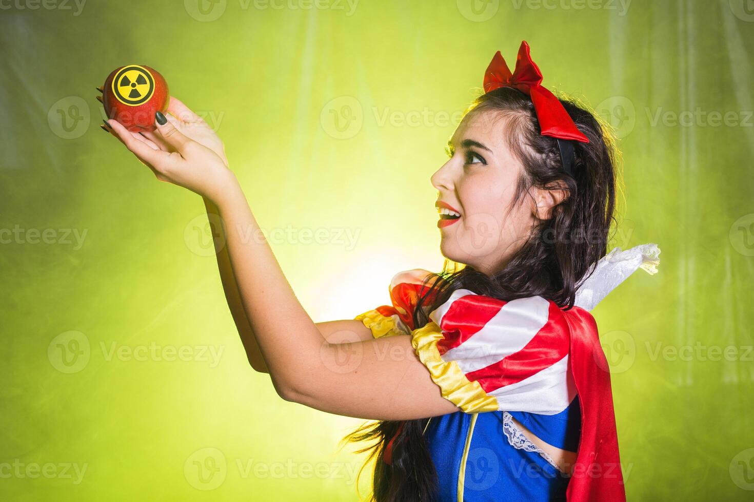 Female wearing a fairy tale dress holding an apple with radiation symbol. Environmental problems concept, radioactive disaster as danger on nature. photo