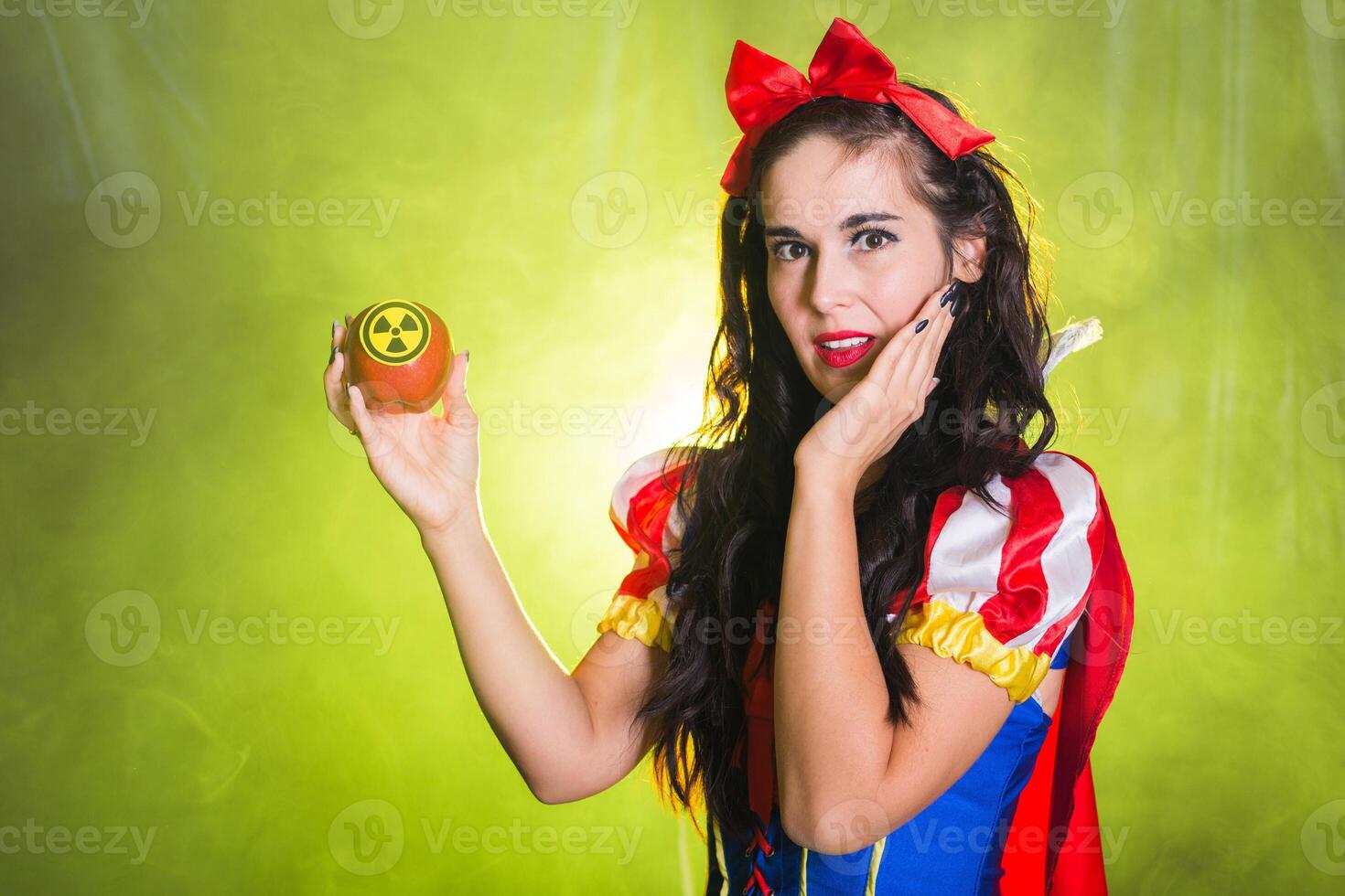 Danger, nuclear and radiation measurement - Surprised female holds apple with radiation hazard symbol. photo