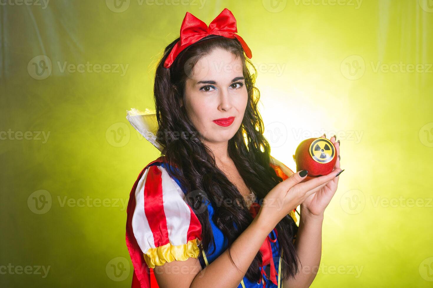 Danger, nuclear and radiation measurement - Portrait of Girl holds apple with radiation hazard symbol. photo