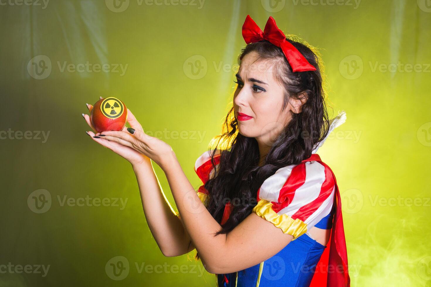 Portrait sad Woman holding hazardous radioactive apple. Nuclear and radiation measurement concept. photo