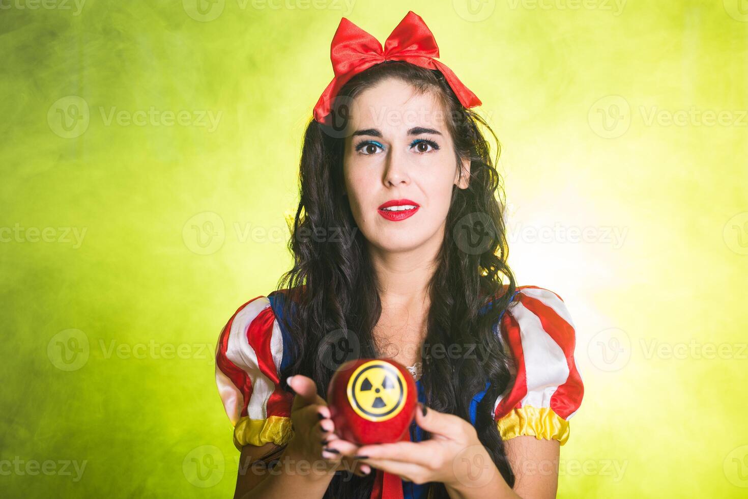 Portrait Woman holding hazardous radioactive apple. Nuclear and radiation measurement concept. photo
