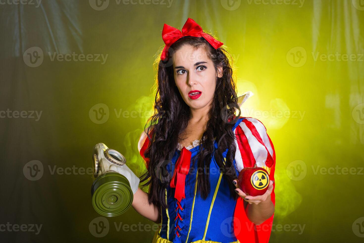 Surprised female holding hazardous radioactive apple. Nuclear and radiation measurement concept. photo