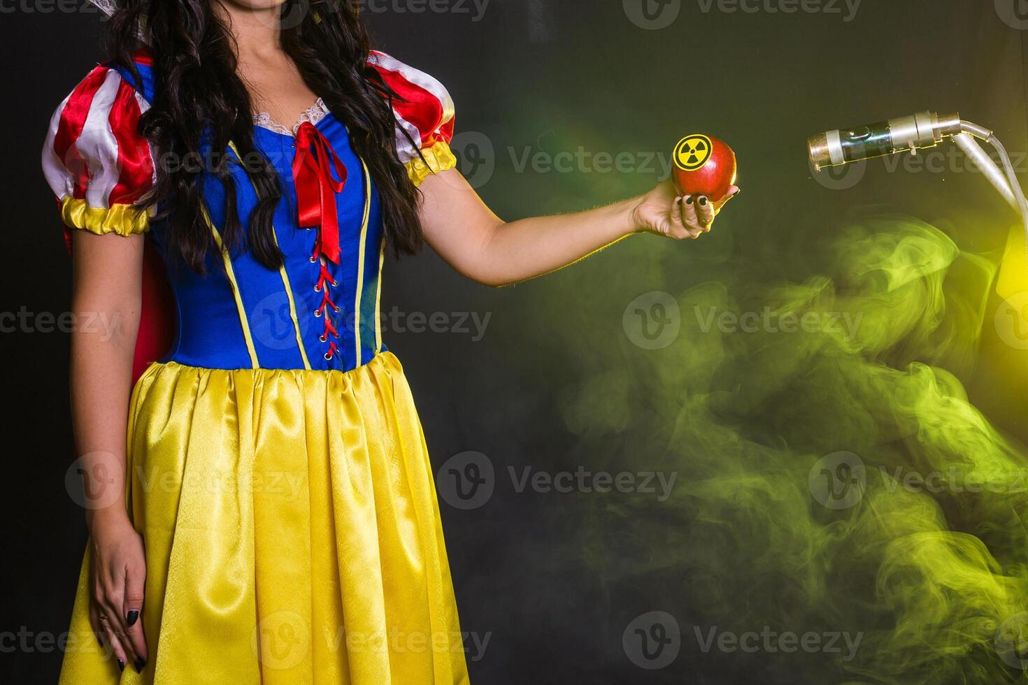 Danger, nuclear and radiation measurement - Close-up female holds apple with radiation hazard symbol. photo
