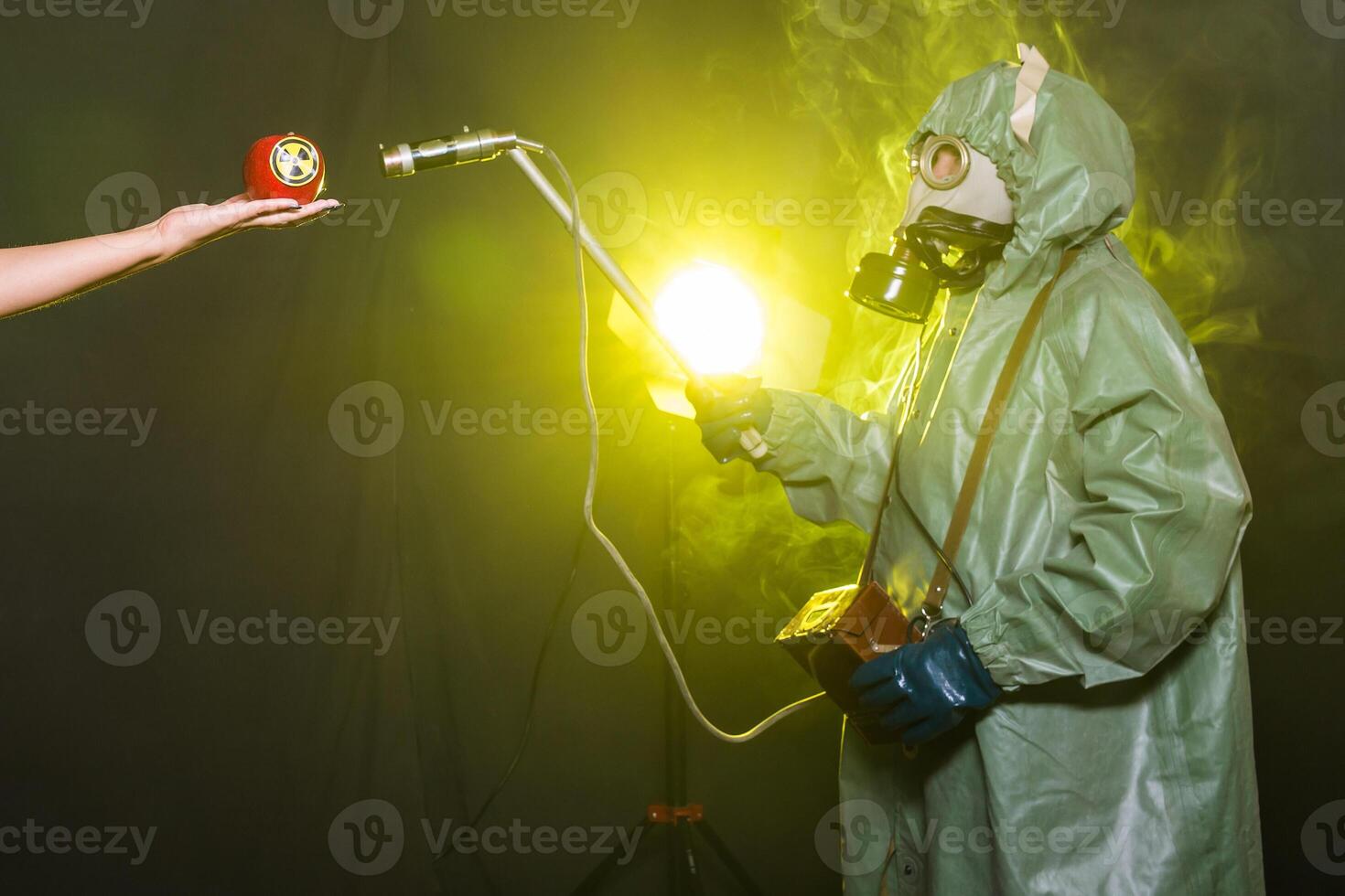 Radiation, pollution and danger concept - Men in protective clothing and a gas mask on a dark background photo
