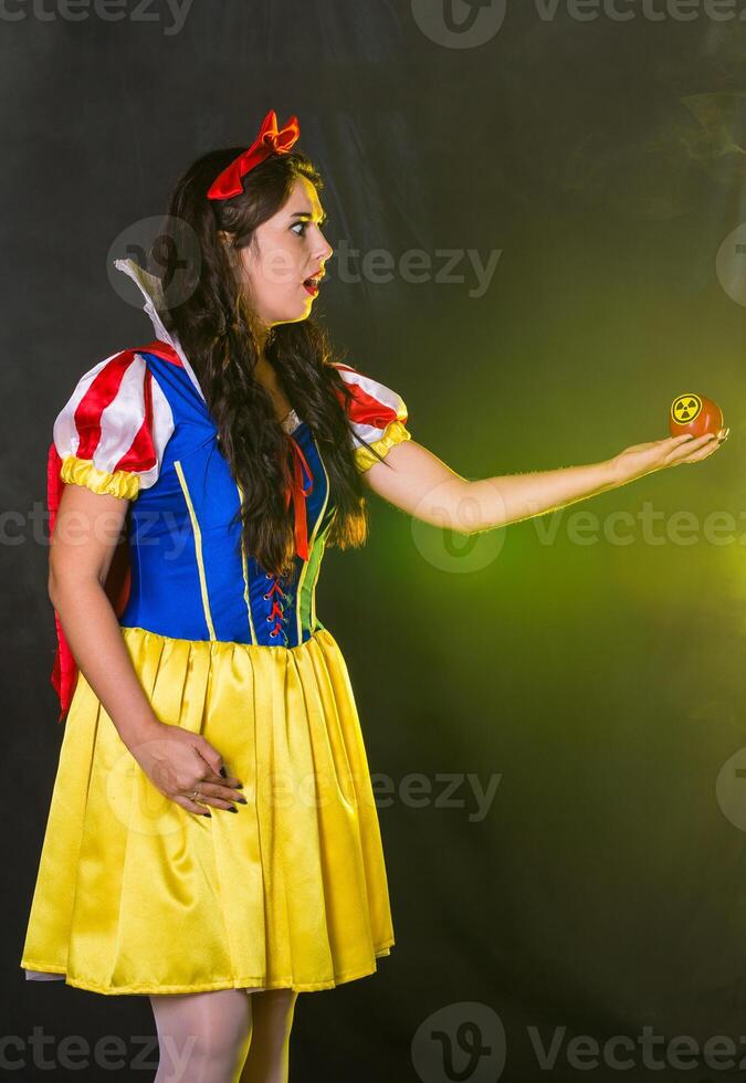Danger, nuclear and radiation measurement - Surprised girl holds apple with radiation hazard symbol. photo