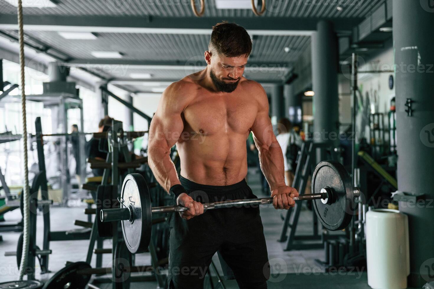 Muscular ,strong man is working out in the,, gym photo