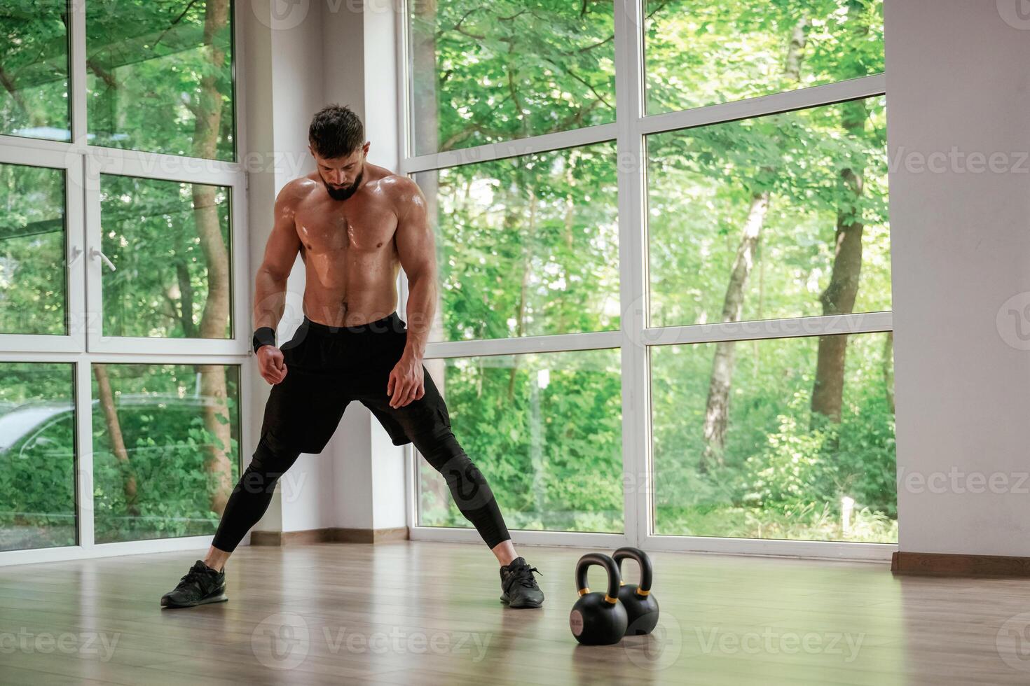 Focused at ,the exercise. Strong muscular man is working out in the gym photo