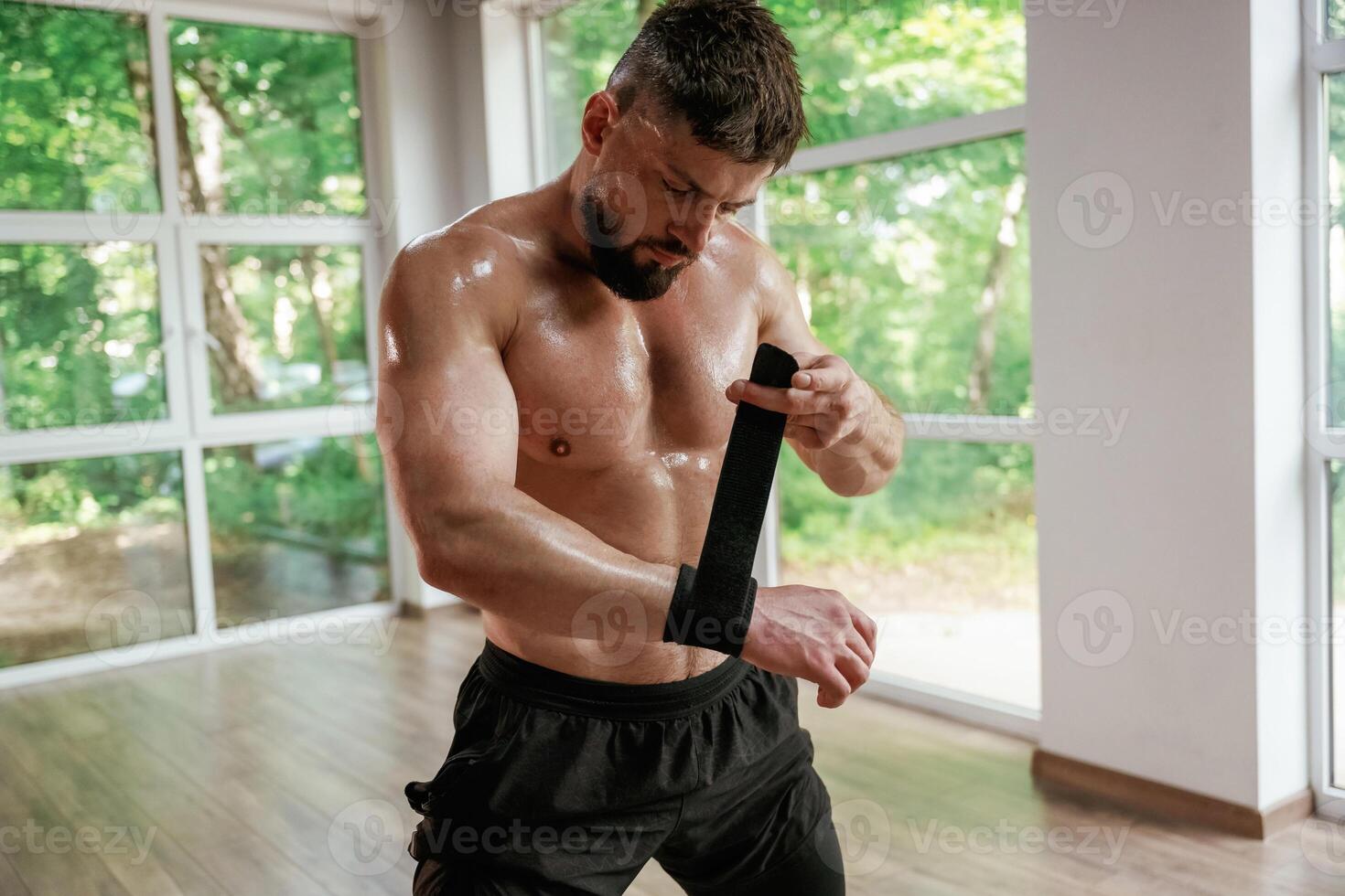 Wearing the ,protective ,bandage on hands. Strong muscular man is working out in the gym photo